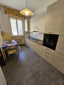 a kitchen with a table and a stove top oven at Riverside San Pellegrino in San Pellegrino Terme +4 photos