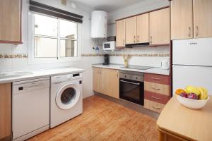 a kitchen with a washing machine and a dishwasher at Apartamento Dayca in Torrox Costa