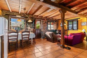a kitchen and living room with a table and chairs at Valle de Bueida La Vega in Rodiles