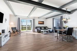 a living room with a couch and a table at Haus Am Meer Familie Frener in Pellworm