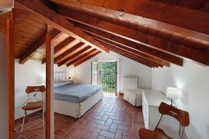 a bedroom with two beds in a room with wooden ceilings at Villa Zafferano in Celle Ligure