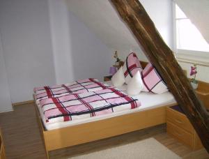 a bedroom with a bed with a comforter and pillows at Haus Margarete in Zell an der Mosel