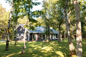 a house in the middle of a yard with trees at The Peaceful Vacation in Muratsi