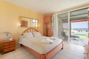 a bedroom with a bed and a view of the ocean at Azahara Beach in Arona +20 photos