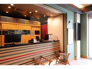 a bar in a restaurant with two chairs at Smile Hotel Kyoto Karasuma Gojo - Vacation STAY 69565v in Kyoto
