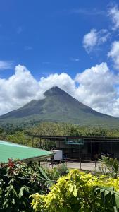 a mountain in the distance with a building in front at Quebrada Honda GlamShack in Pueblo Nuevo