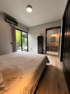 a bedroom with a large bed and a large mirror at Quebrada Honda GlamShack in Pueblo Nuevo