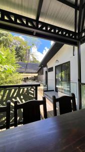 an external view of a house with a table and chairs at Quebrada Honda GlamShack in Pueblo Nuevo