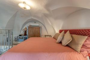 a bedroom with a large bed with an orange bedspread at La Cartapesta in Lecce