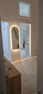 a living room with white walls and a tile floor at Bellini Holiday House in Mola di Bari +24 photos