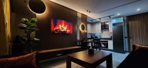 a living room with a fire on the wall at Cosy Maarif Arena by Viva Stay in Maarif