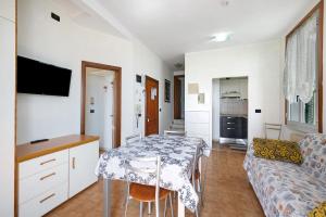 a kitchen and living room with a table and a couch at Numero 7 in Borgio Verezzi