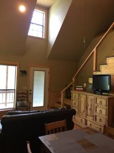 a living room with a couch and a tv at White River Landing in Calico Rock