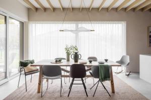 a dining room with a table and chairs at HYGGE Golf House in Gowinko