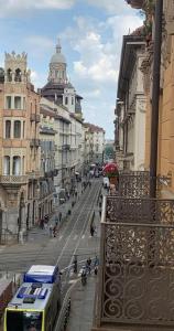 a bus driving down a city street with buildings at SUYTE Torino Centro in Turin +3 photos