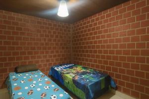 a corner of a room with a bed and a chair at Casa Maré Alta – Piscina e Sossego em Tabuba in Santa Luzia +11 photos