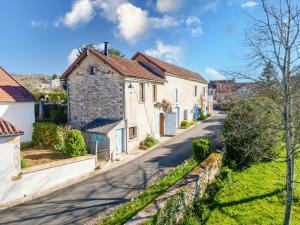 a row of white houses on a street at Gite La Grange - Perigord Vert in Saint-Martial-dʼAlbarède