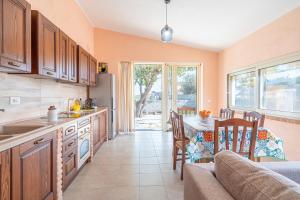 a kitchen with a table and a dining room at Villa Garbugli in Pachino