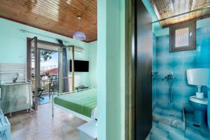 a guest room with a bed and a bathroom at Old Boat double studio 11 in Nikiana +12 photos