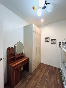 a bedroom with a mirror and a dresser at 2br Unit in Matina Enclaves Davao in Davao City +4 photos