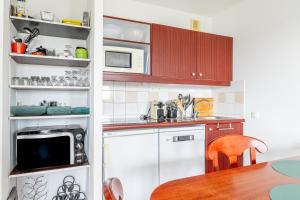 a kitchen with white cabinets and a counter top at 123 - Charme, piscine et évasion in Pornic +14 photos