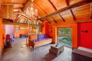 a living room with orange walls and a couch at Borgo Tassani in Casaleggio Boiro +79 photos