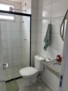 a bathroom with a toilet and a shower and a sink at Buriti Home in Lucas do Rio Verde