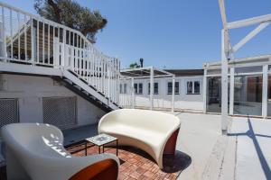 a patio with two white chairs and a staircase at Oliwood Beach - Fantasia in Playa Oliva Nova