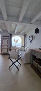 a bedroom with a bed and a chair in it at il Carrubo in Finale Ligure