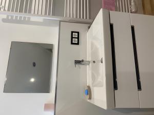 a white cabinet with a sink in a room at Haus Gutach in Schonwald im Schwarzwald +24 photos