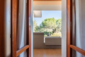 an open door to a bathroom with a window at Albergo Il Tegolo in Cerreto Guidi