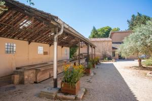 a building with a greenhouse with flowers in it at Mas J des Sens - petit dej compris in Le Val