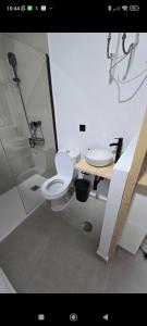 a bathroom with a toilet and a sink at Estudio in Conil de la Frontera +5 photos