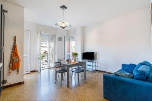 a living room with a blue couch and a table at Iris Apartment Lago Maggiore in Angera