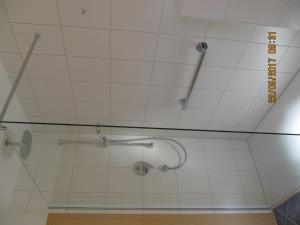 a bathroom with a shower with a glass wall at Landhaus Erben in Wasserburg am Bodensee +57 photos