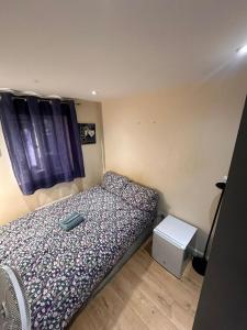 a small bedroom with a bed and a window at BUDGET Small Rooms in Thamesmead