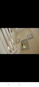 a stairway with a mirror and a stair case at BUDGET Small Rooms in Thamesmead +1 photo