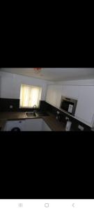 a small kitchen with a sink and a window at BUDGET Small Rooms in Thamesmead