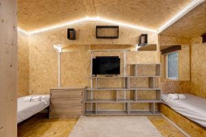 una piccola stanza con due letti e una tv di Nature Stone and Villas a Vila Boa do Bispo