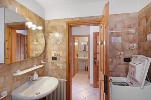 a bathroom with a sink and a toilet and a mirror at Agritur Ciasa Do Pare in Festilli +52 photos