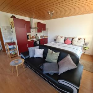 a living room with a couch and a bed at Offenburger Hof in Schuttertal