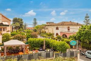 a view of a street with a house and a garden at Chiara Home Apartment in Giardini Naxos