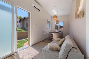 a living room with a couch and a large window at Casa Teresa Suite in Como in Como