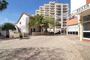 an empty street in front of a building at Family Beach View - Praia da Rocha in Portimão