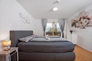 a bedroom with a bed and a table and a window at Martin´s Alm in Friesenried