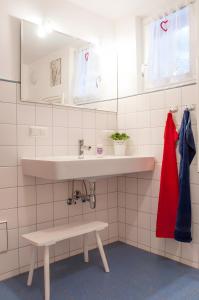 a bathroom with a sink and a bench under it at Gästehaus Minkel in Gudensberg +52 photos