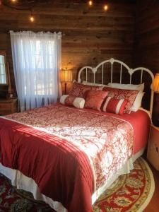 a bedroom with a large bed in a log cabin at Meadow Creek Cabin in Camino