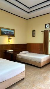 Postel nebo postele na pokoji v ubytování Rani Homestay