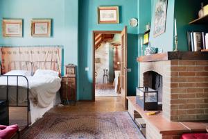 a bedroom with a bed and a fireplace at Il Flauto Magico delle Langhe in Serralunga d'Alba