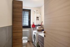 a small bathroom with a refrigerator and a toilet at Casa Vacanze Giorgia - Caspoggio in Caspoggio +18 photos
